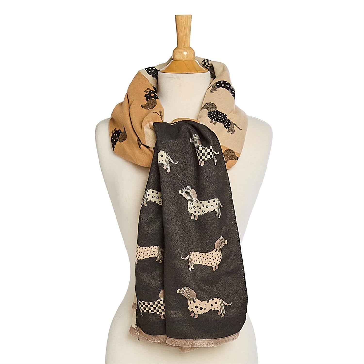 Mannequin wearing a reversible black & beige scarf with   differant shades of beige & back with dachshund dog patterns on a white background.