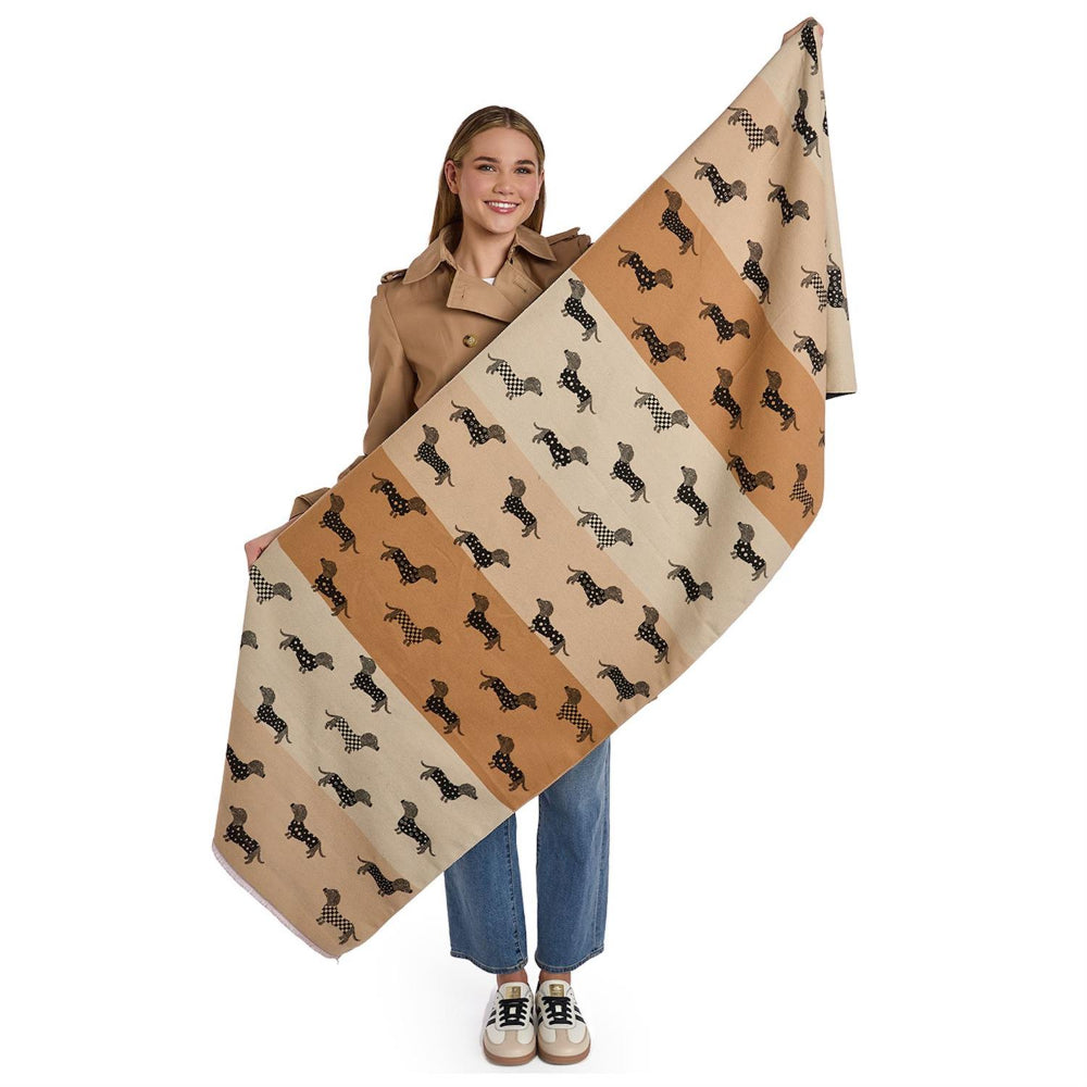 Person holding a reversible black and beige scarf with black dachshund dog patterns with differant shades of beige on a white background.
