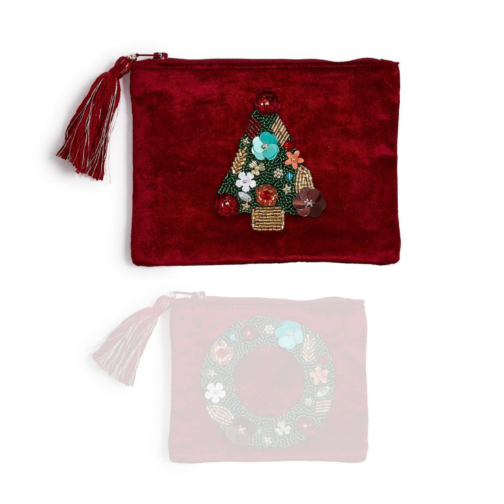 A burgundy pouch with a holiday tree design and tassel on a white backround. 