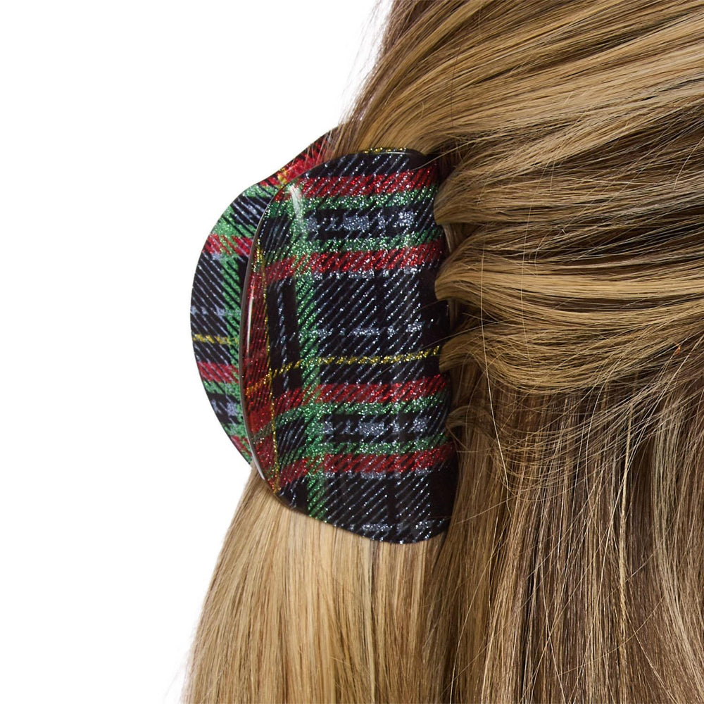 Multicolored plaid hair cilp in use on a white background