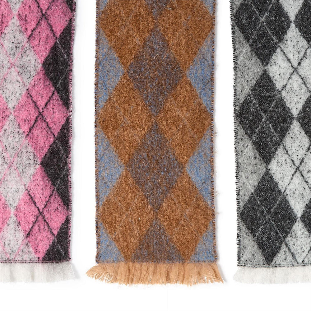 Close up of three dimond plaid patterned scarves in pink, brown, and black on a white background