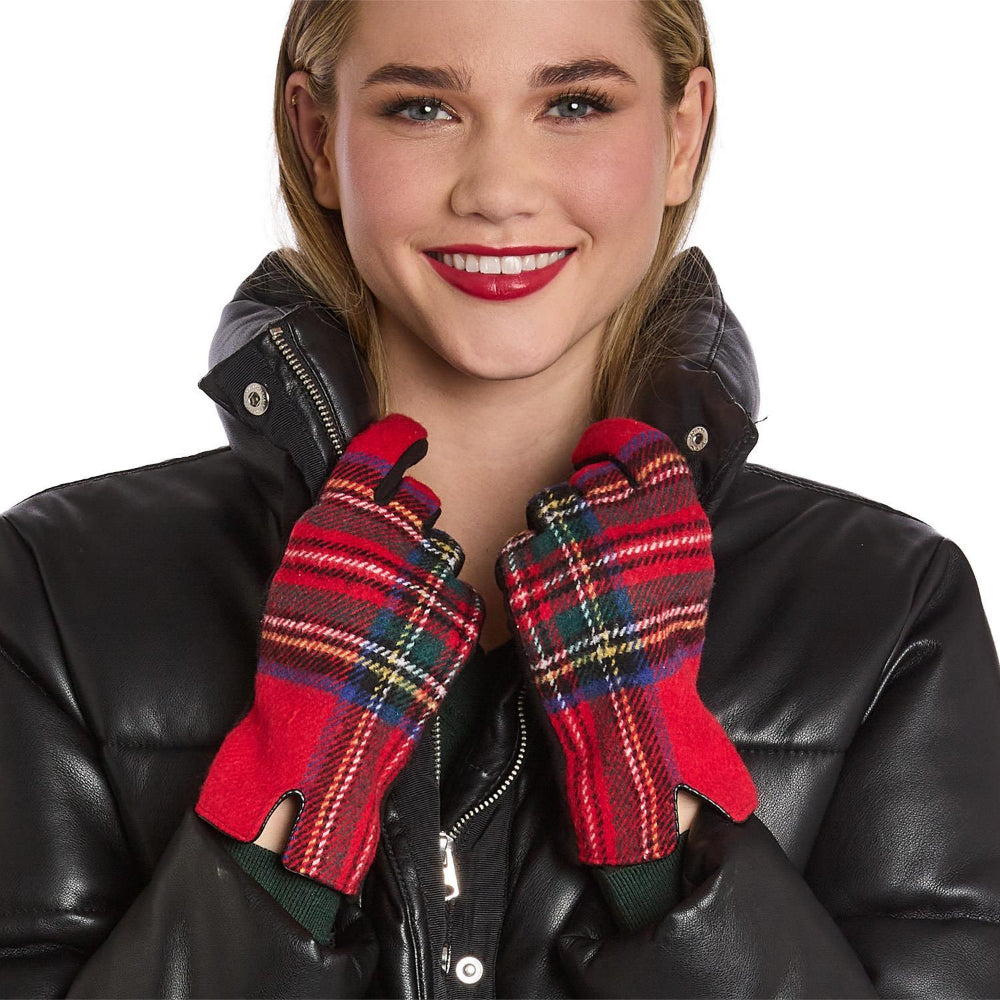 Woman wearing red plaid gloves with a black leather jacket on a white background