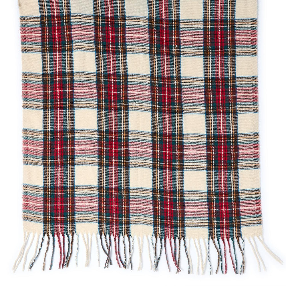 A close up photo of a white, red & green plaid scarf with fringes on a white background.
