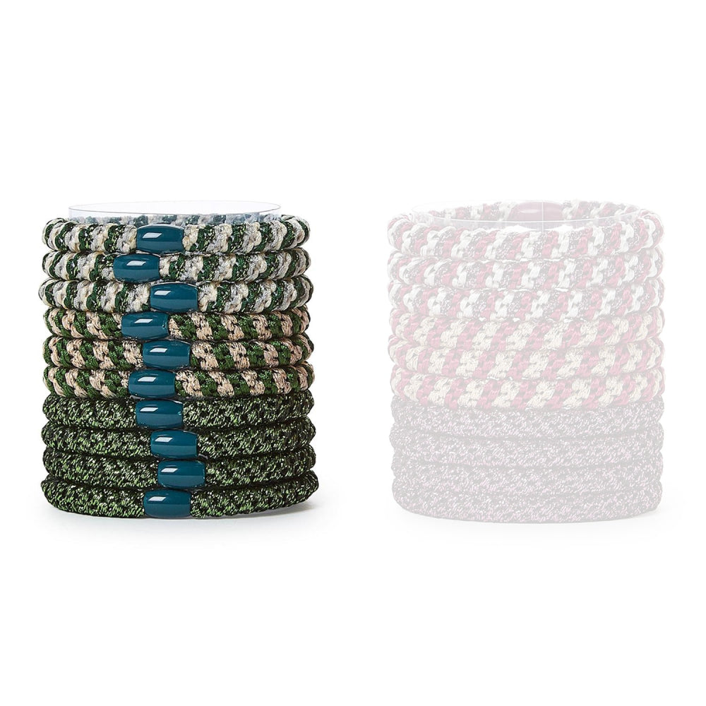 Set of colorful green hair ties in a stack with a single pink and gray tie on a white background.