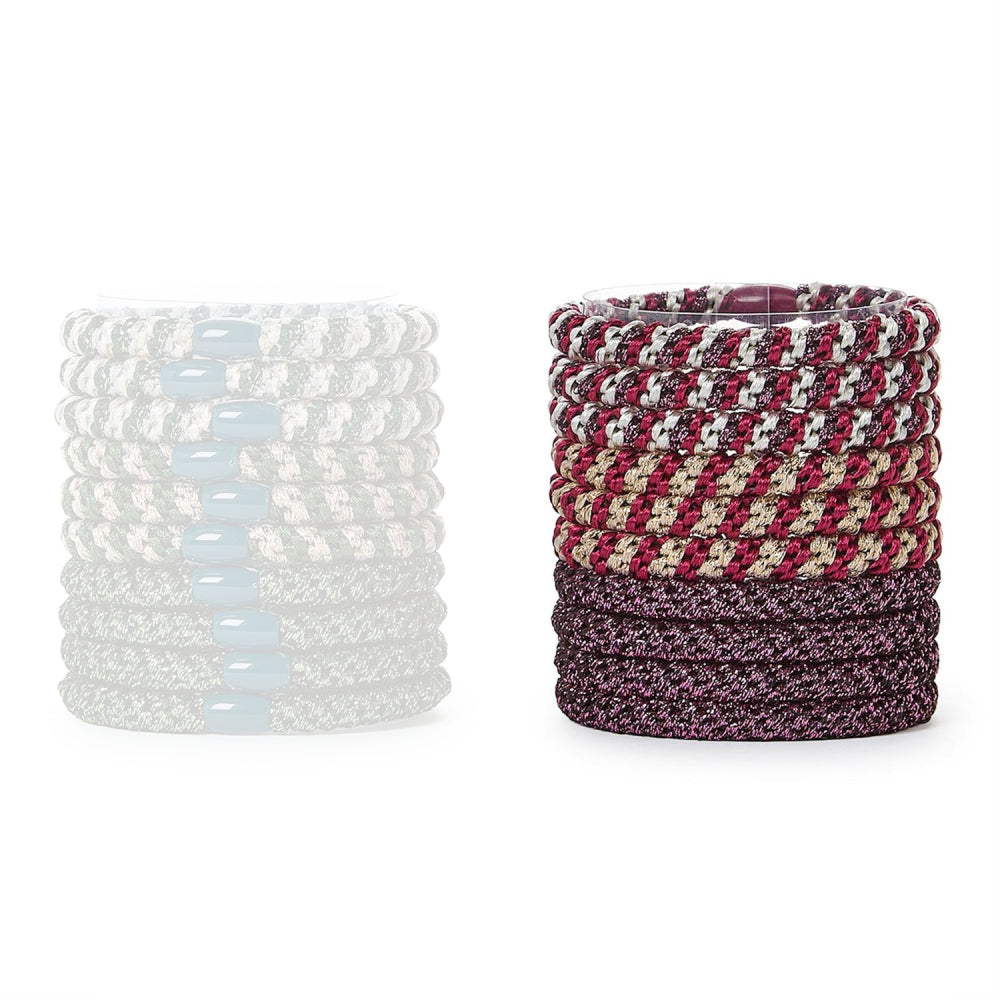 Set of colorful red hair ties in a stack with a single pink and gray tie on a white background.
