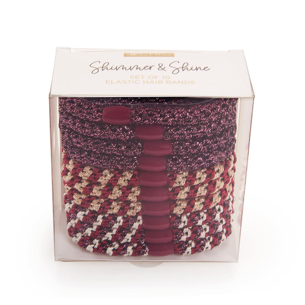 Packaged red set hair ties with a houndstooth pattern and glittery accents, branded 'Shimmer & Shine'.