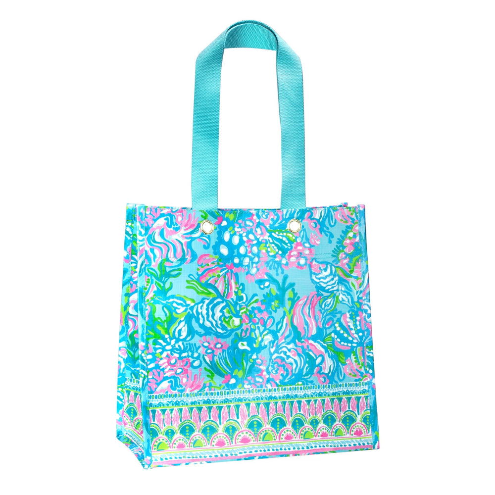 Colorful tote bag with a floral and animal pattern on a white background.