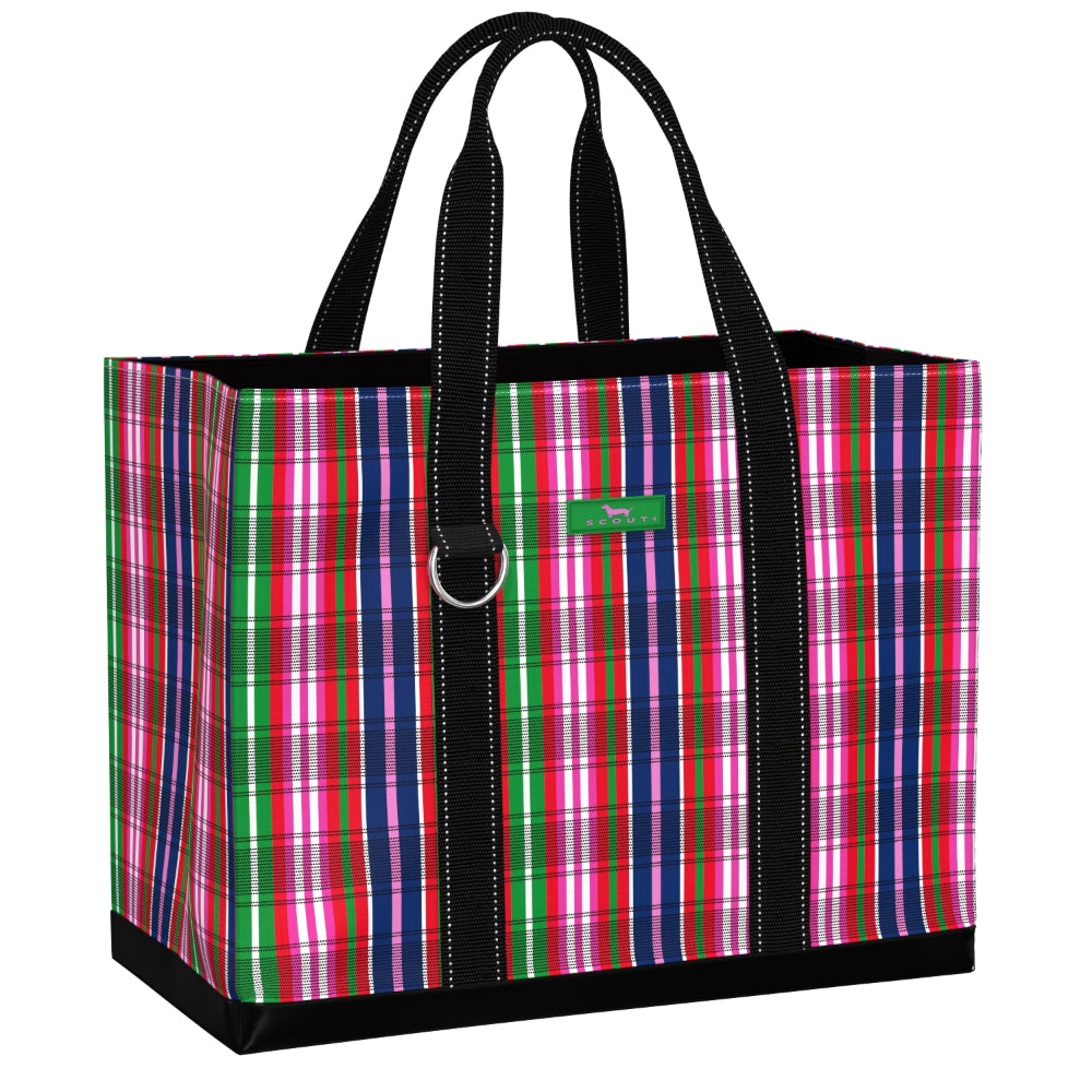 A tote bag with a vibrant pink, green, and blue plaid pattern, black handles, and a small green brand tag on the front.