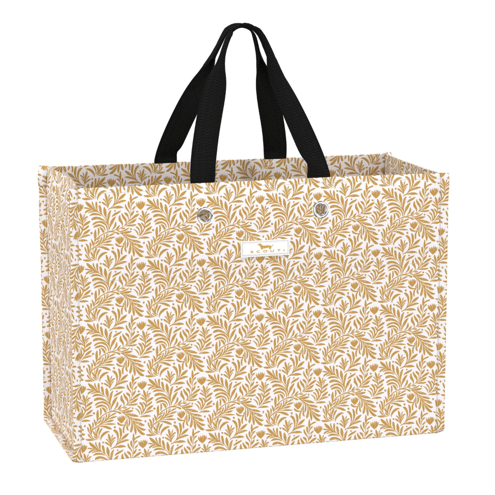 A large gift bag with a repeating gold botanical leaf pattern on a white background, featuring two black shoulder straps and a small white brand label on the front.