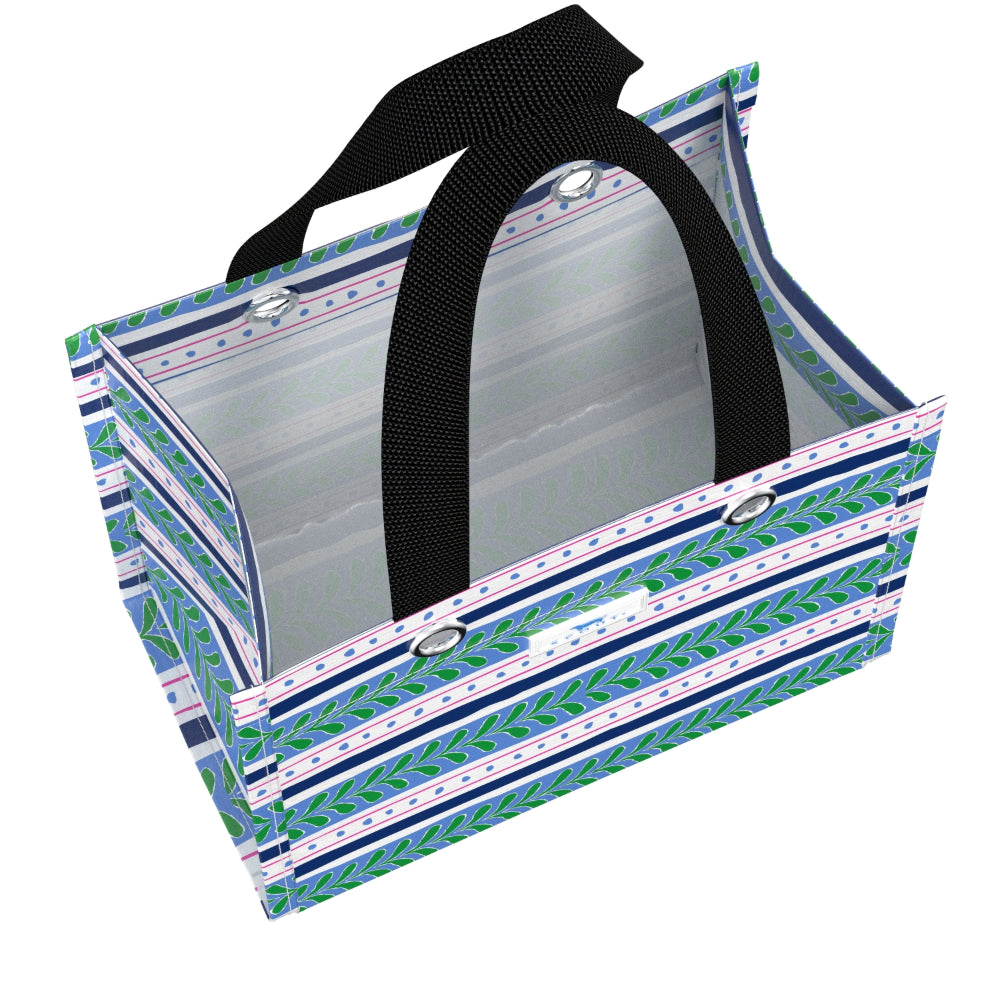 A rectangular gift bag with a geometric pattern of navy blue, green, and white stripes, featuring black webbed handles and silver metal grommets.