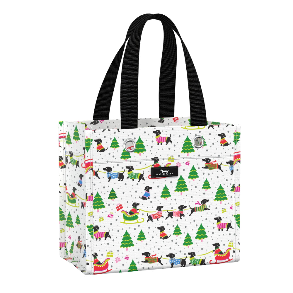 Gift bag with Christmas-themed design featuring trees, presents, and dogs on a white background