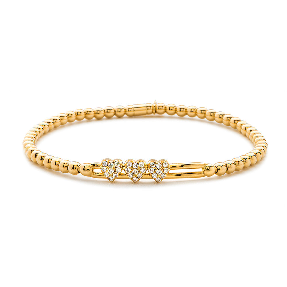 Gold bracelet with heart-shaped clasp on a white background