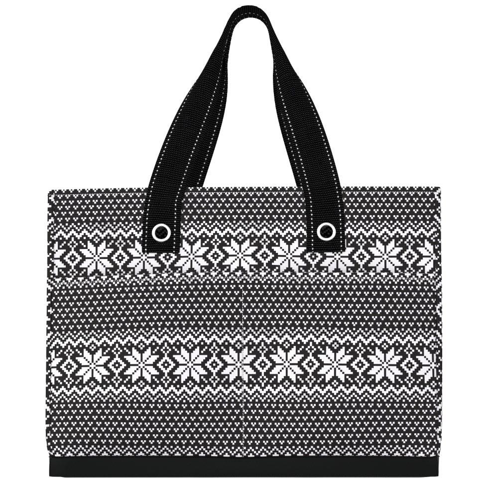 A black and white patterned tote bag with a Nordic fair isle snowflake design and black shoulder straps, shown against a plain white background.