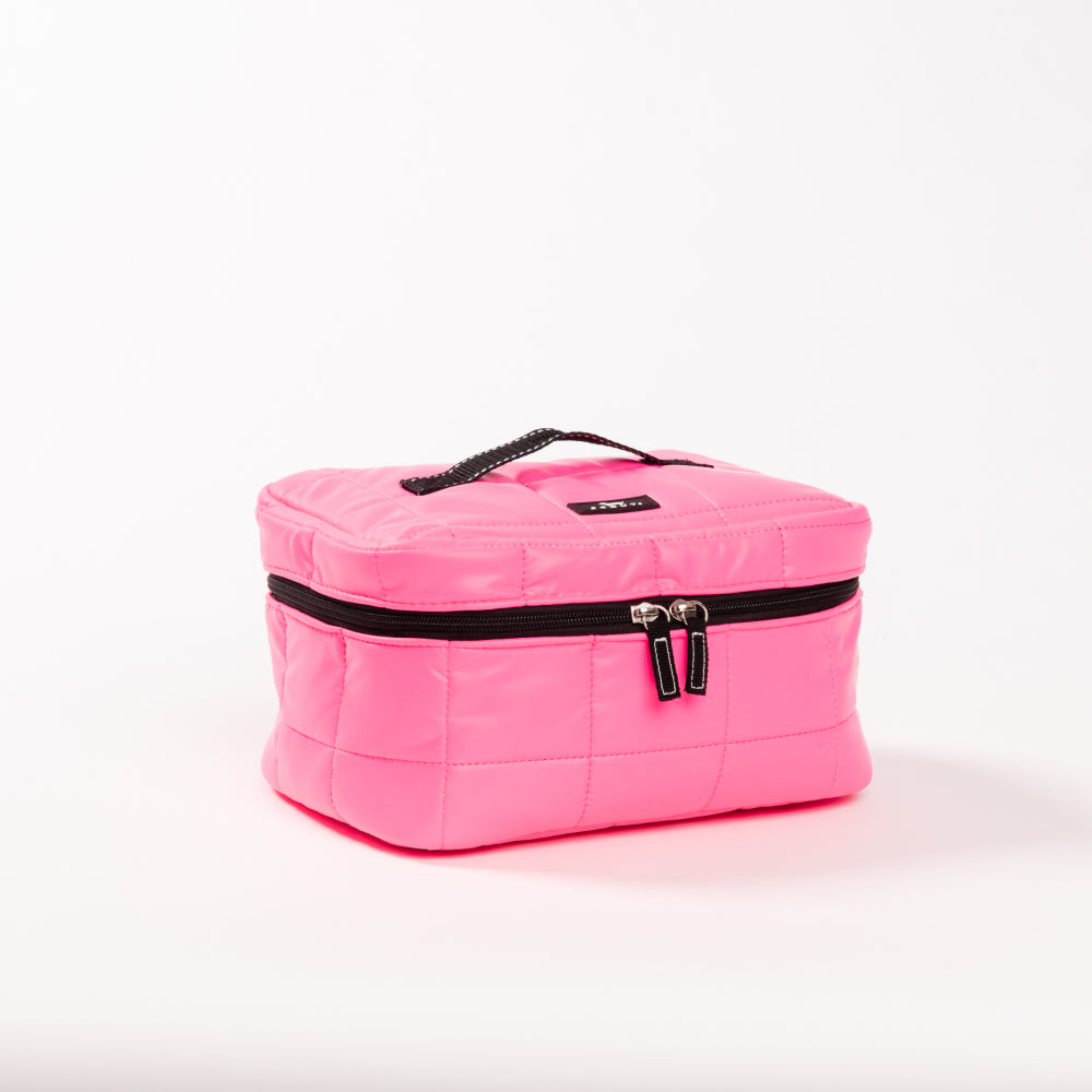 Pink quilted makeup bag with black zippers on a white background