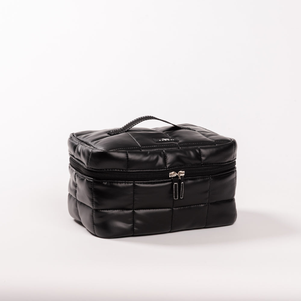 Black quilted cosmetic bag on a white background