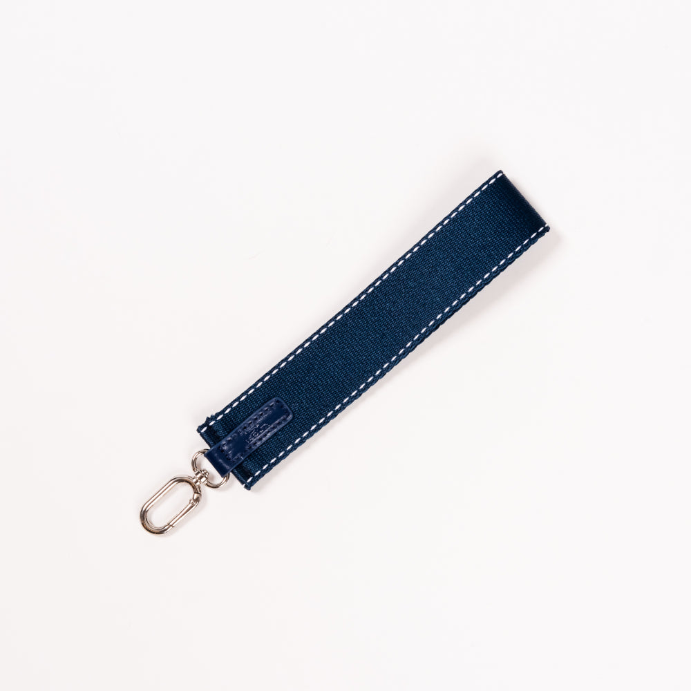 Navy blue keychain strap with gold clip on a white background