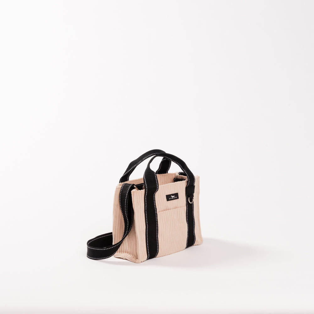 Beige handbag with black straps on a white background