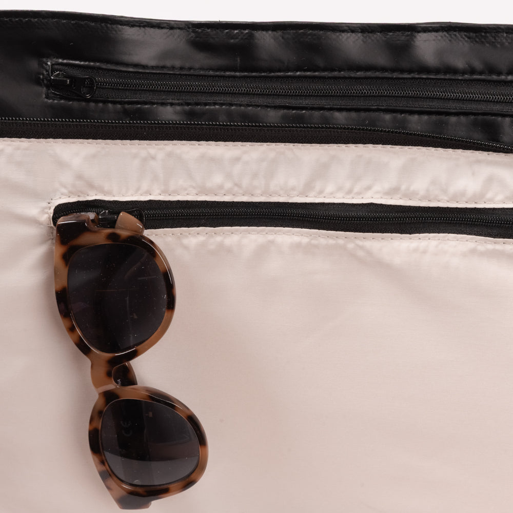 Sunglasses with tortoiseshell frame and dark lenses on a white surface.