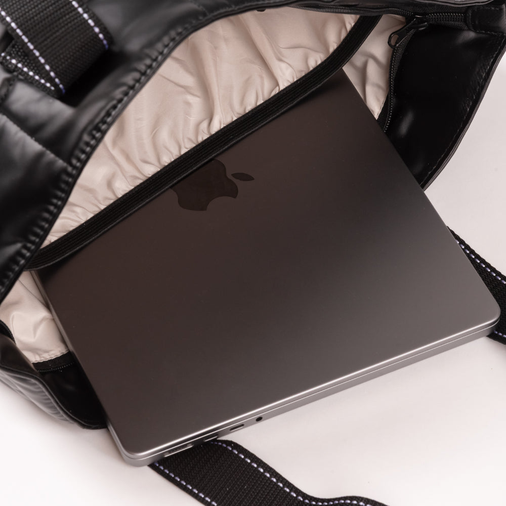 Laptop inside a black backpack on a white background
