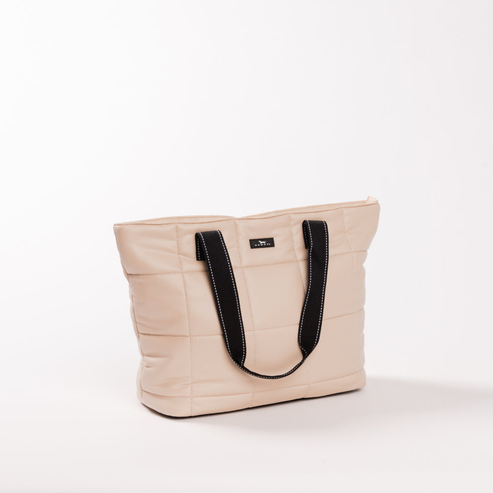 Beige tote bag with black handles on a white background
