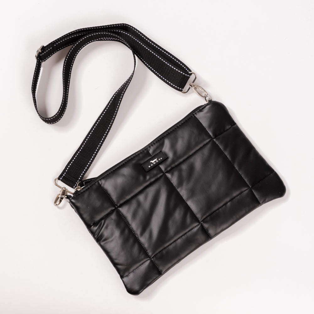 Black quilted handbag with a strap on a white background