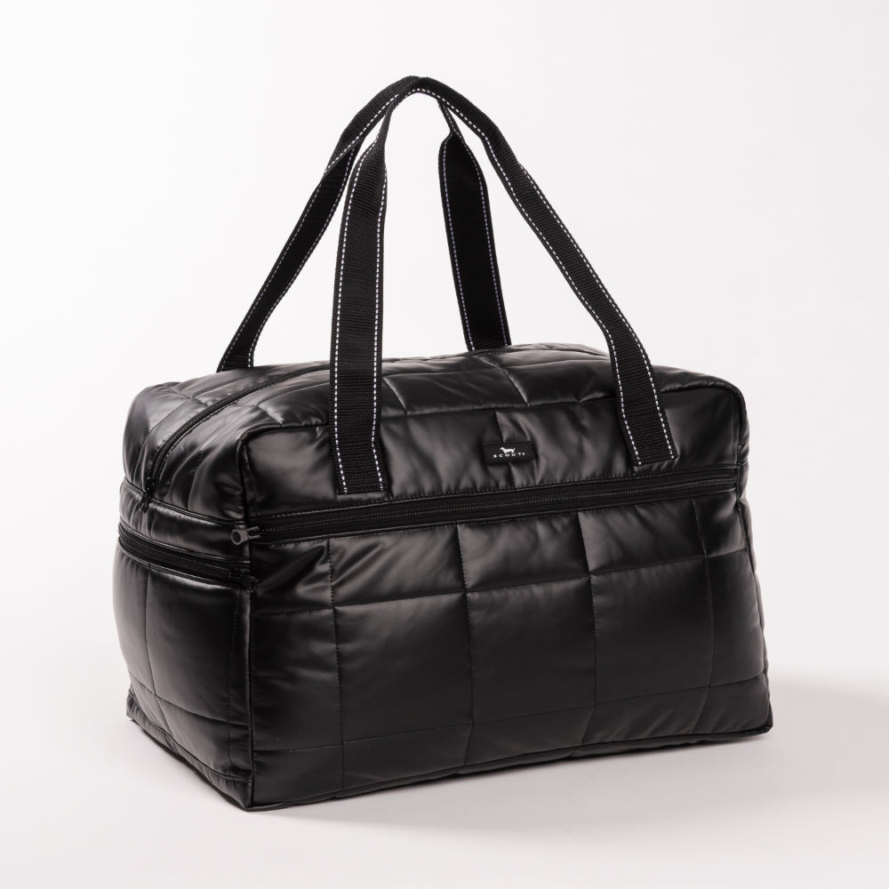 Black quilted duffel bag on a white background