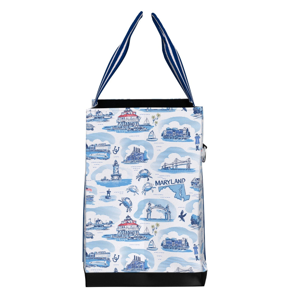 A tote bag featuring a light blue and white Maryland-themed illustration pattern with navy blue and white striped handles, black trim, and a black base.