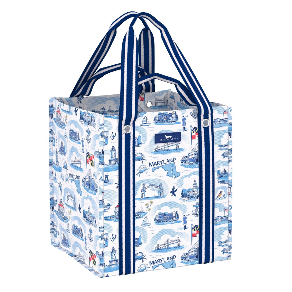 A square reusable tote bag with a blue and white Maryland-themed illustration pattern, featuring navy blue and white striped handles and side trim, shown on a plain white background.