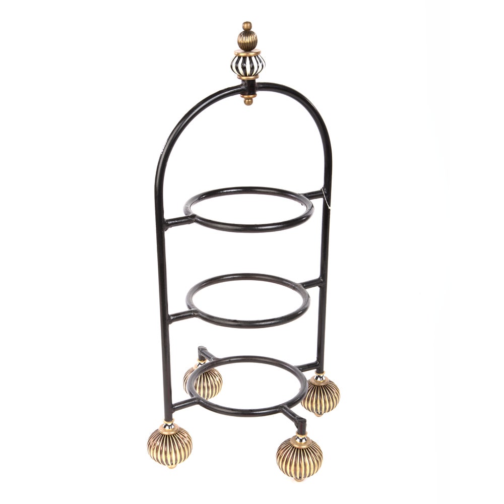 Decorative metal stand with three circular shelves and gold accents on a white background