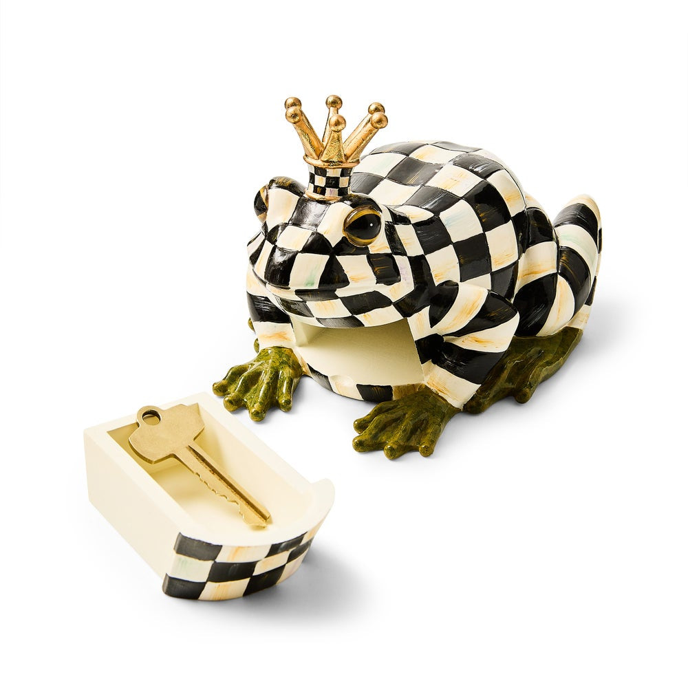 Checkered frog figurine with a crown and key on a white background