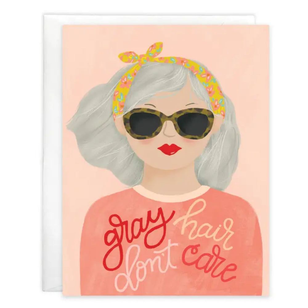 A birthday greeting card with an old lady on the front of the card and text "gray hair don't care" on a white background.