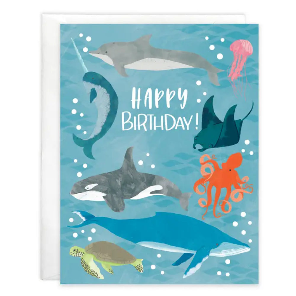 Birthday card with ocean-themed illustrations of dolphins, jellyfish, and other sea creatures on a blue background.