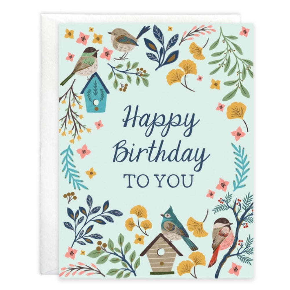 Birthday card with birds, birdhouses, and floral elements on a light green background