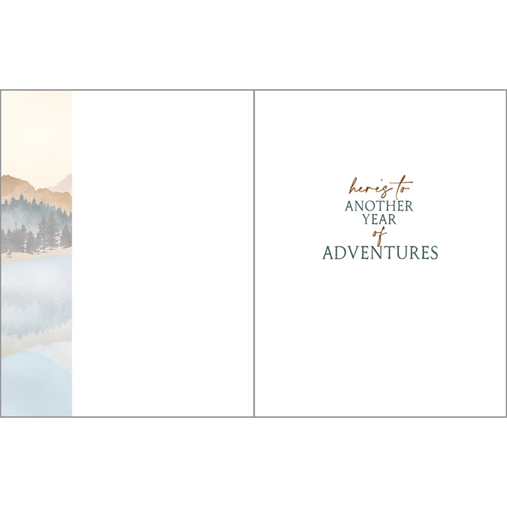 Inside birthday greeting card with text "here's to another year of adventures"