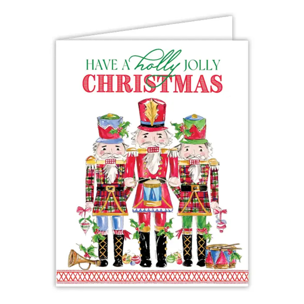 A Christmas greeting card featuring three illustrated nutcracker soldiers in colorful holiday uniforms, with the text 'HAVE A Holly JOLLY CHRISTMAS' at the top on a white card.