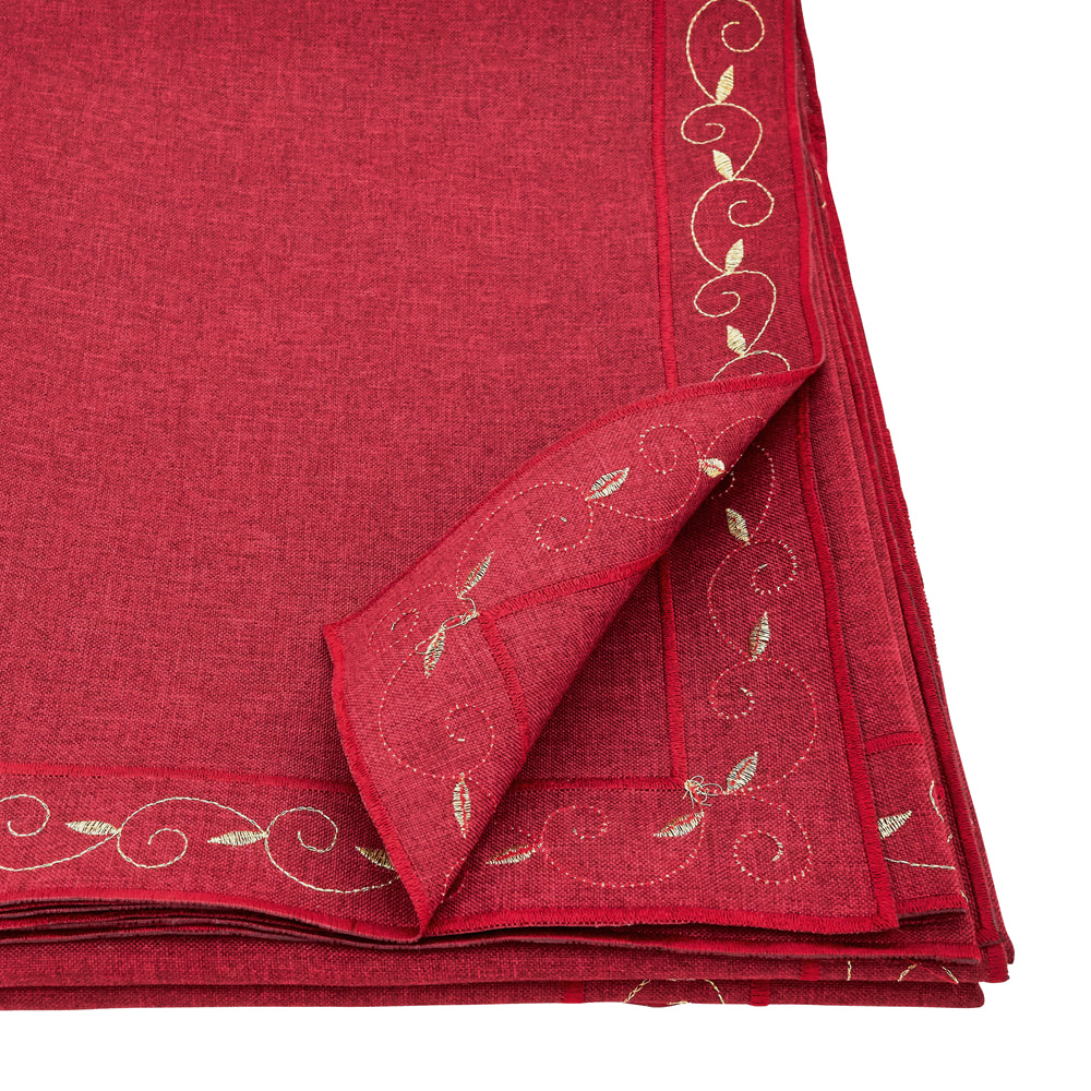 A folded red tablecloth with a textured linen-like weave and delicate gold embroidered vine patterns along the border, shown on a white background.