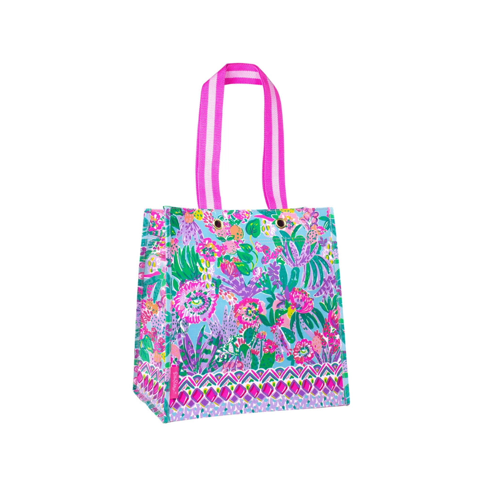Colorful patterned tote bag with pink handles on a white background.