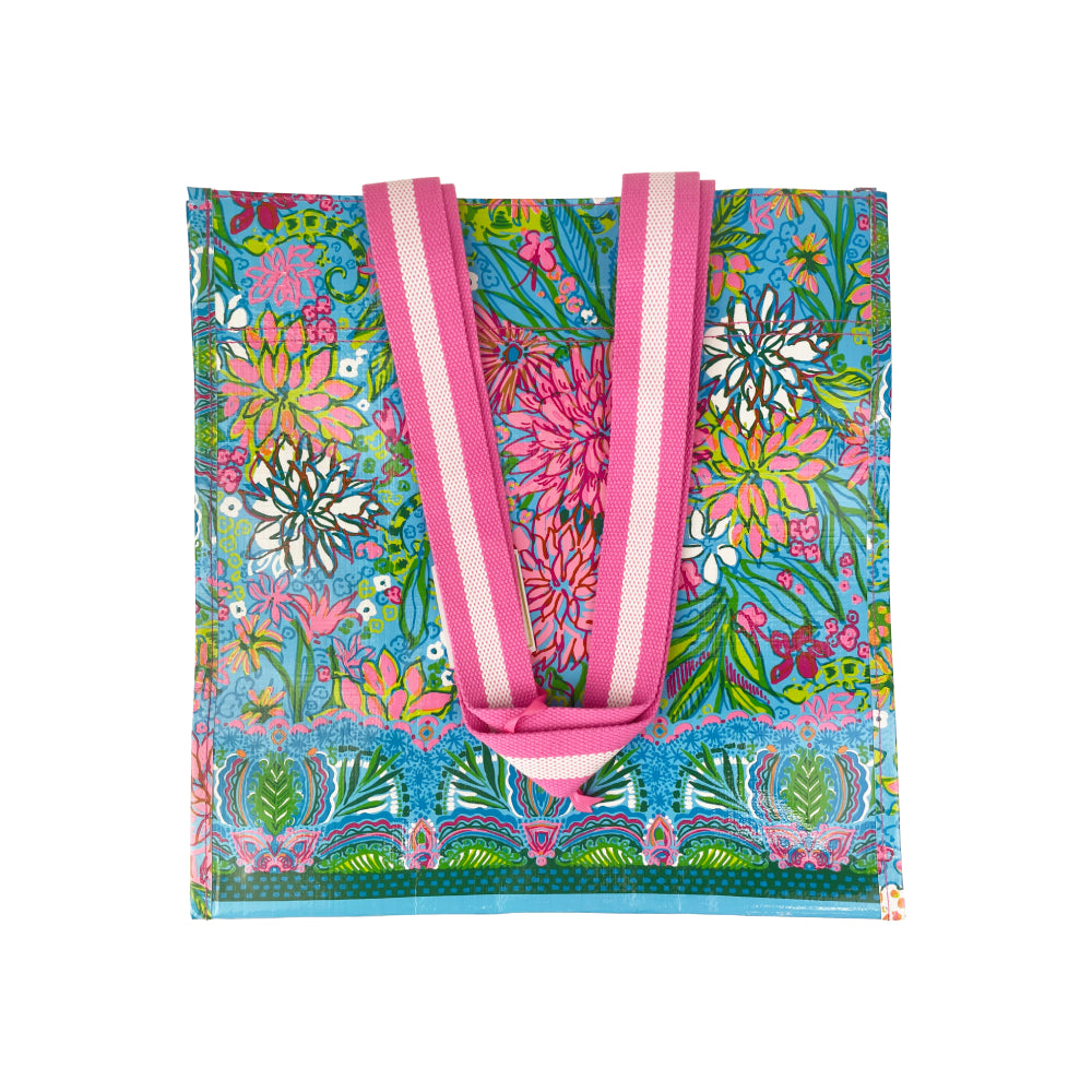 Lilly Pulitzer multi color flower design polypropylene tote bag on a white background.