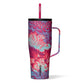 A pink floral colored Corkcicle Cold Cup XL with a flat handle and a silicone straw tab, triple insulated and cup holder friendly.