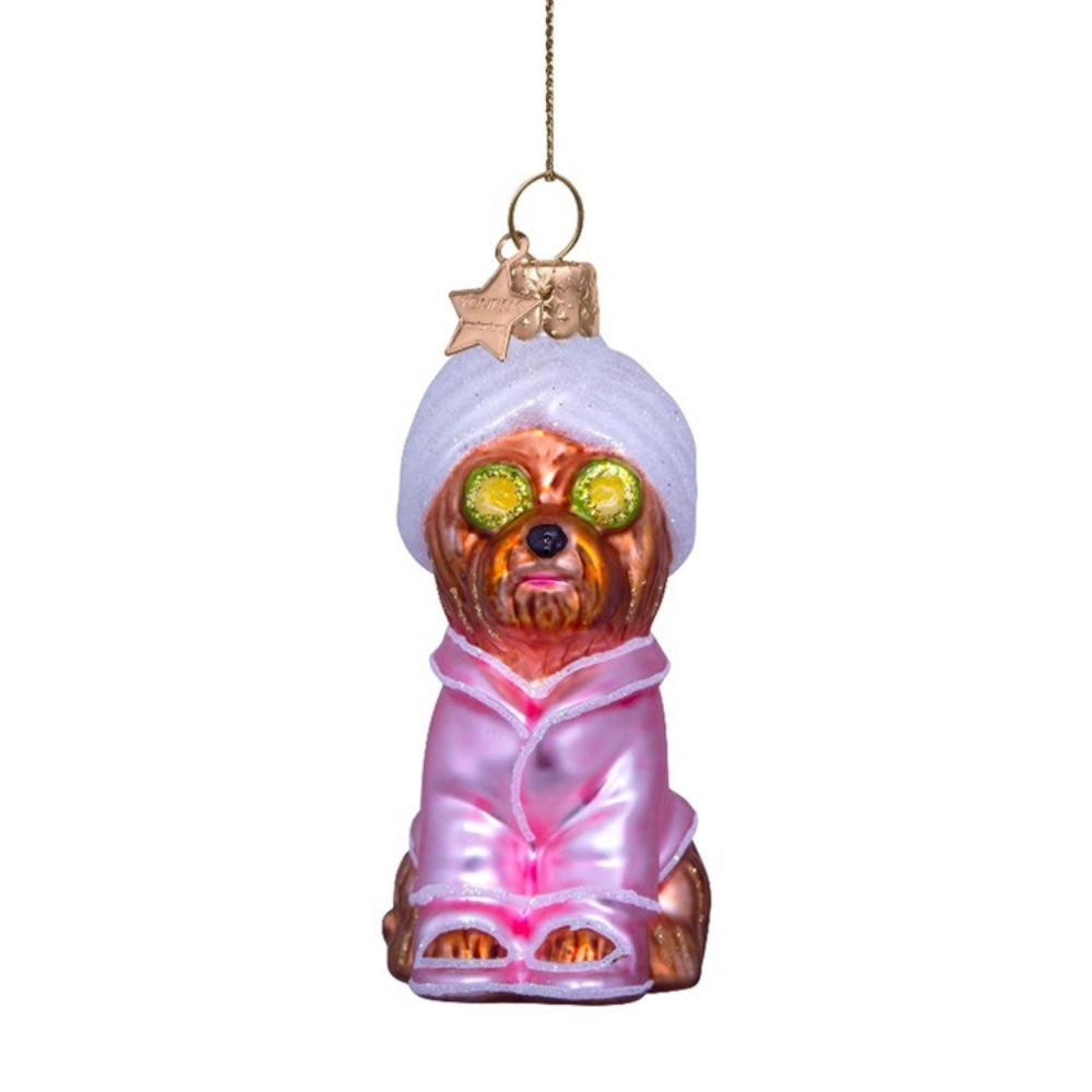 Glass ornament of a dog in a towel and pink robe with sunglasses on a white background