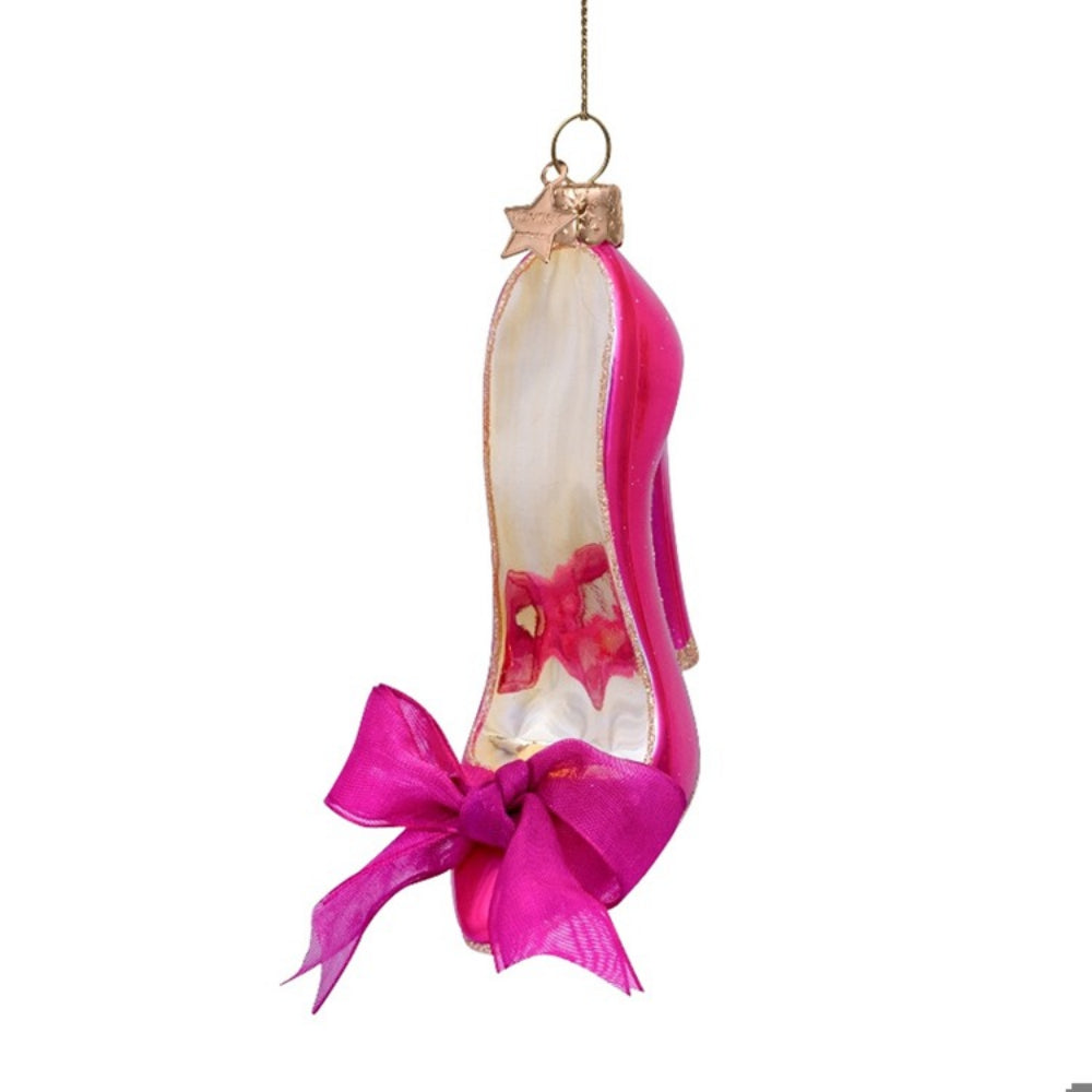 Glass ornament shaped like a high-heeled shoe with pink ribbon on a white background