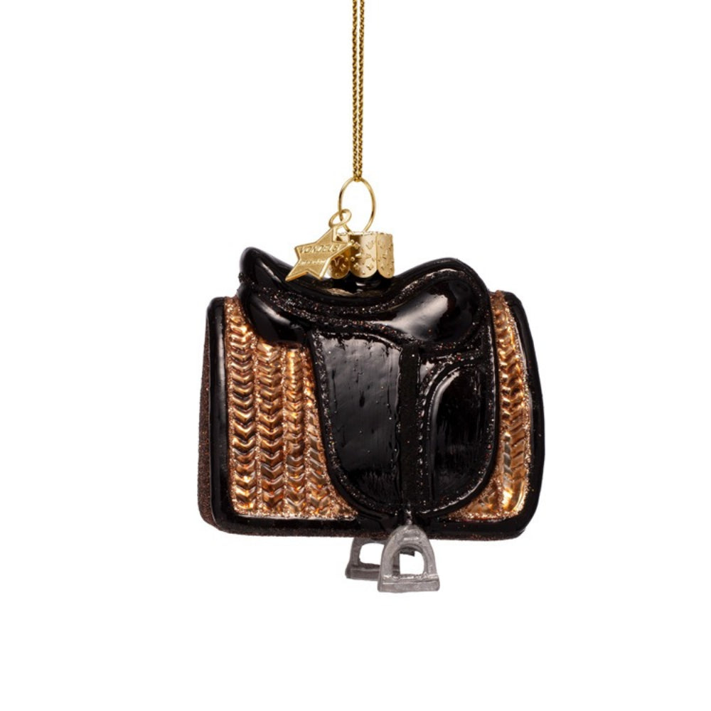Decorative glass ornament of a black and gold saddle with a gold chain on a white background