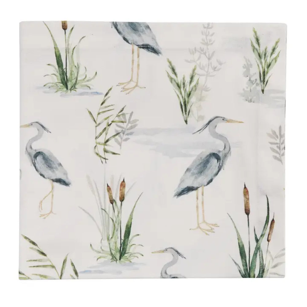 Blue Heron Napkin with Heron bird design on it on white background. Plant designs next to Heron. 