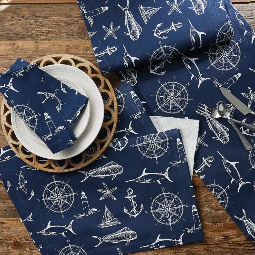 Navy table runners, napkins, and other homegoods and home decor items on wooden table surface. 