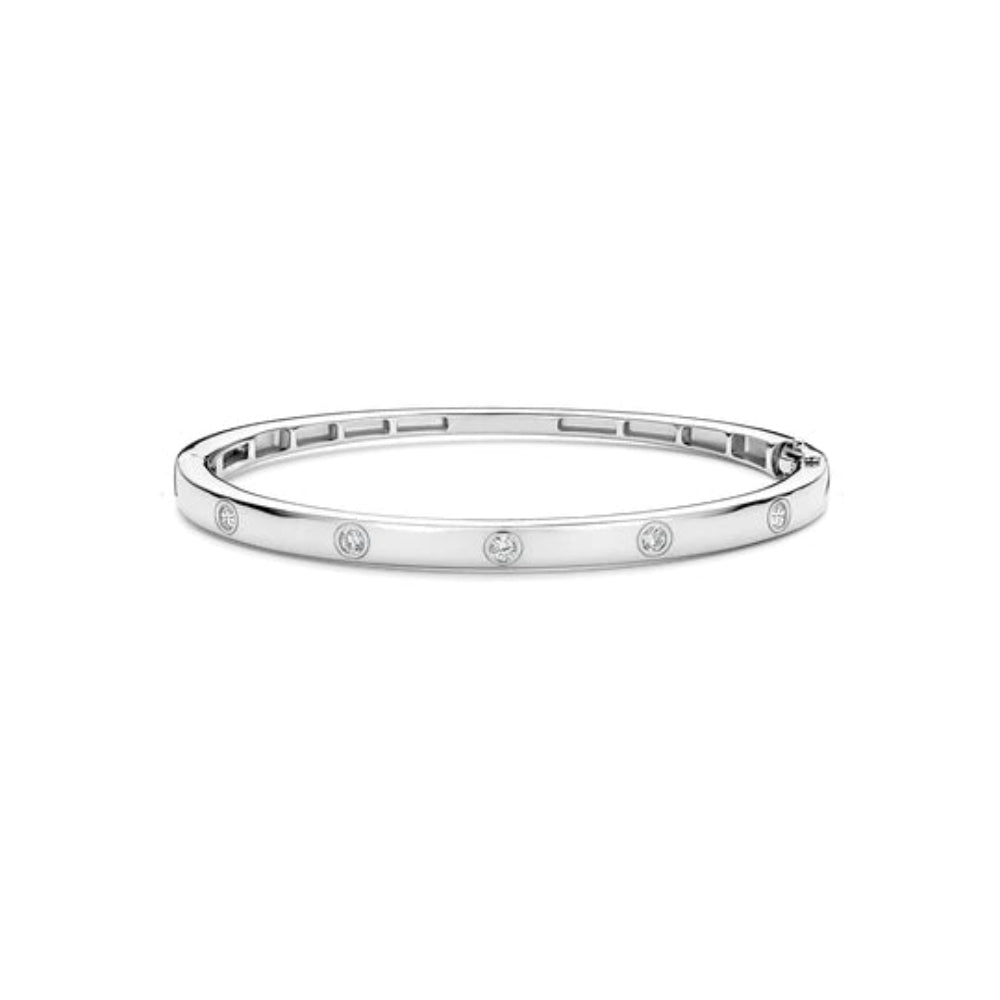 A slim silver bangle bracelet with evenly spaced round bezel-set clear stones.