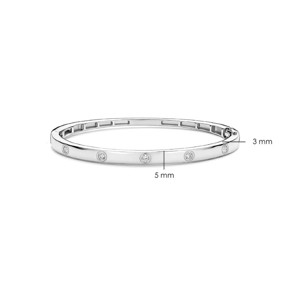 A silver-toned bangle bracelet with small round inset stones