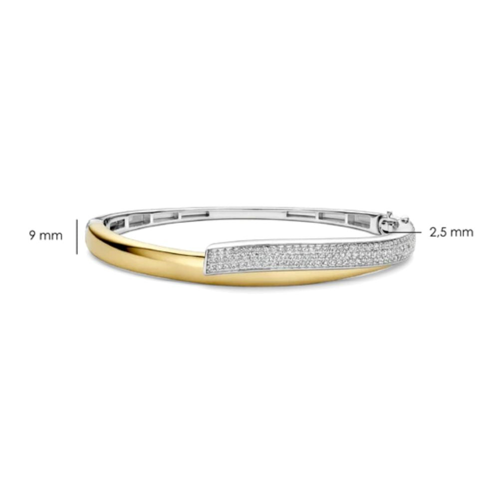 A two-tone silver and yellow gold bangle bracelet with a row of pavé-set clear stones and a twist dimension labels indicating 9 mm width and 2.5 mm thickness.