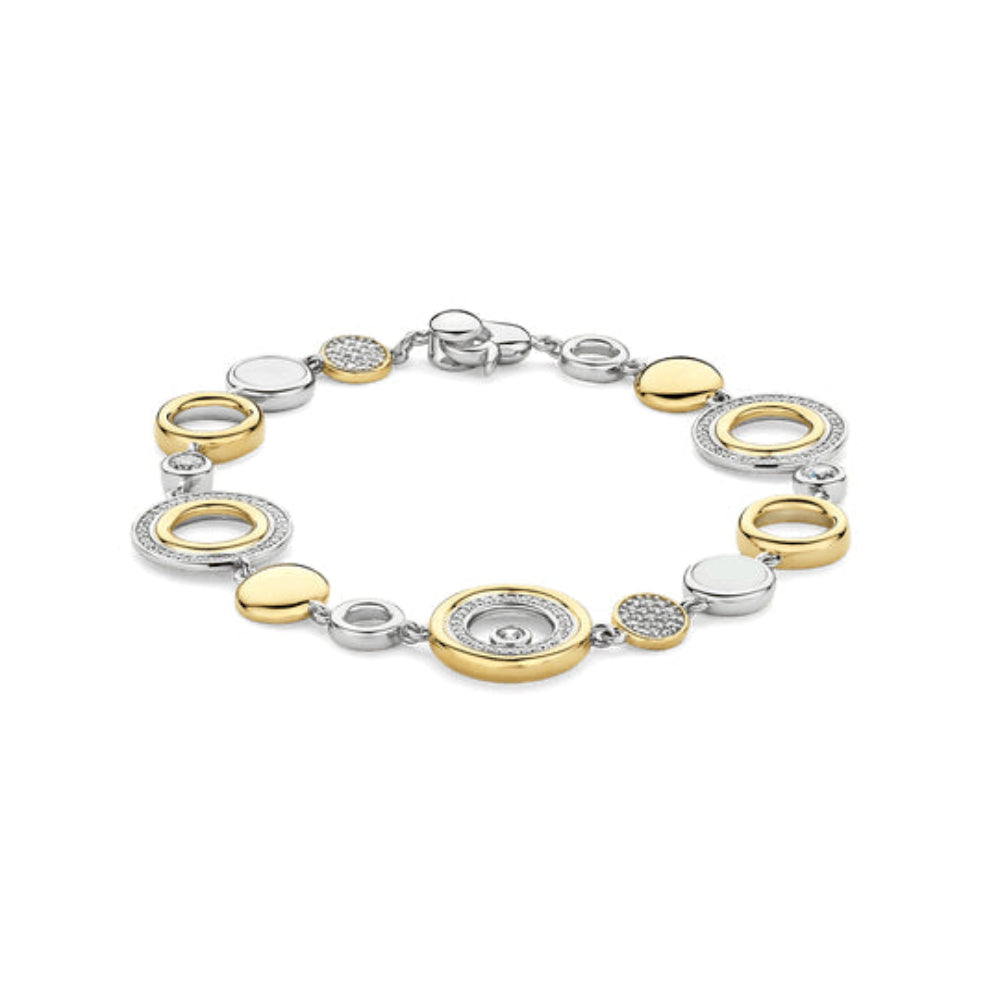 A two-tone yellow gold and silver chain bracelet with circular disc charms, some adorned with small clear crystals, 
