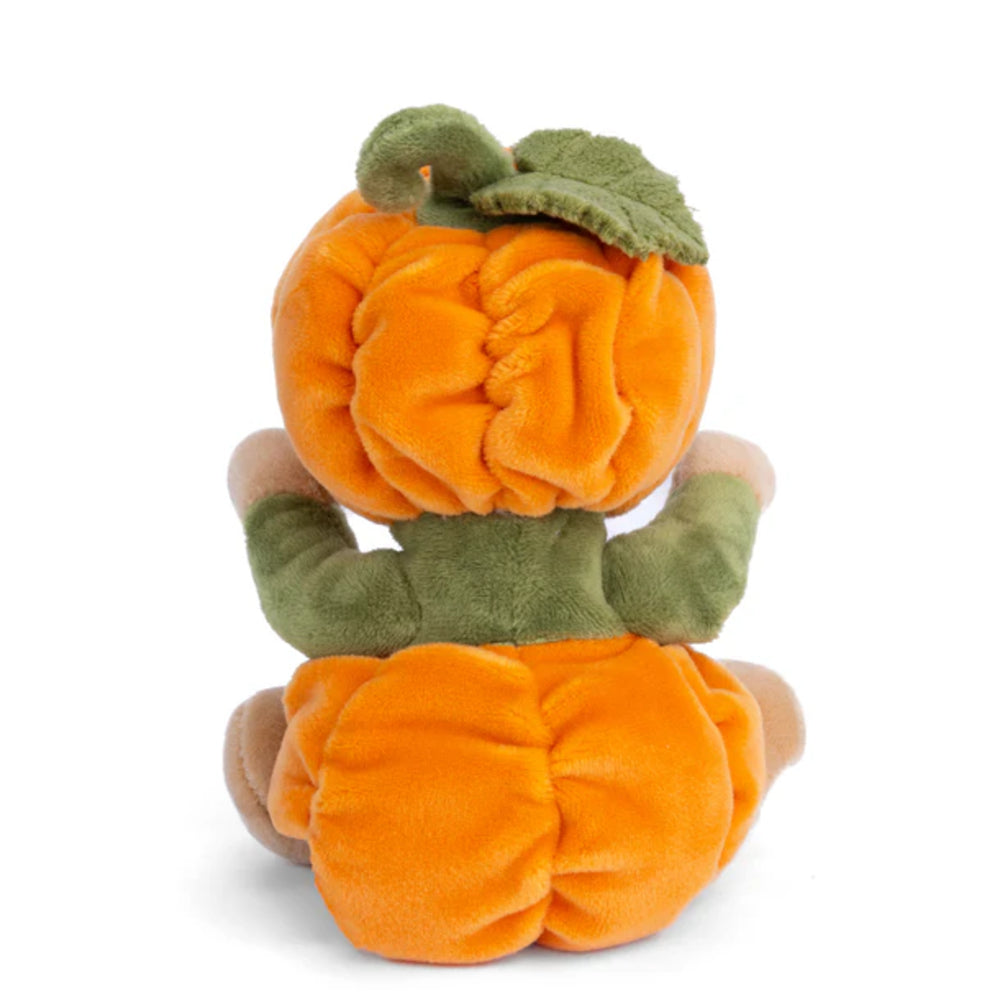 A photo of the back of a white teddy bear in an orange & green pumpkin costume on a white background.