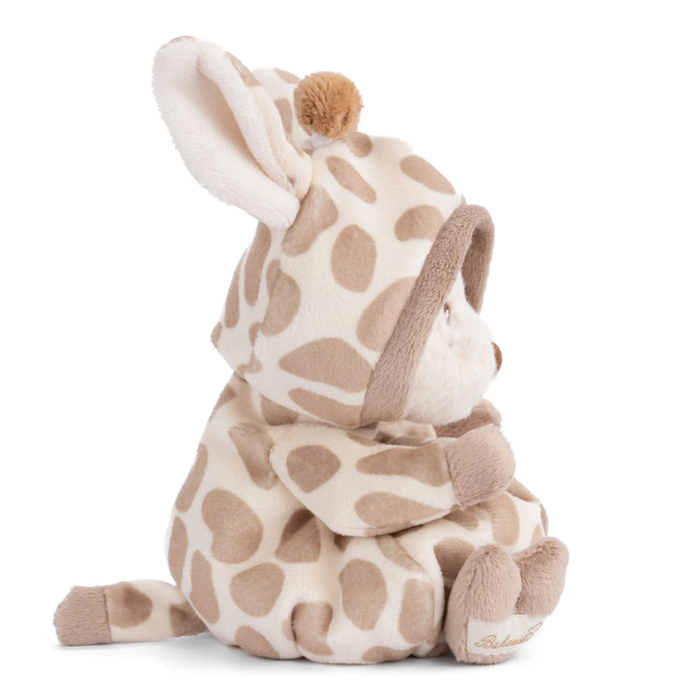 A side photo of a teddy bear dressed in a giraffe robe with a hood on a white and brown pattern on a white background.